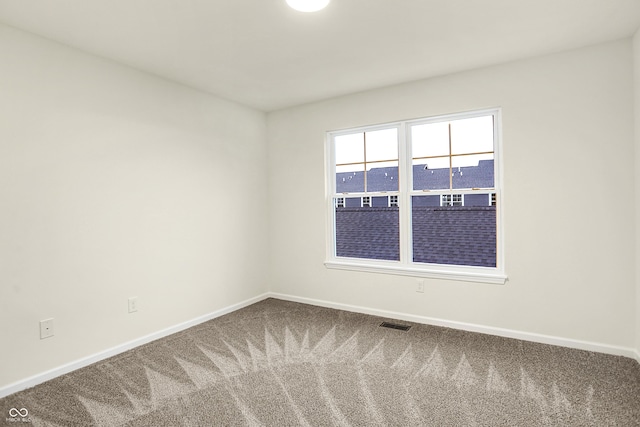 unfurnished room featuring visible vents, baseboards, and carpet floors