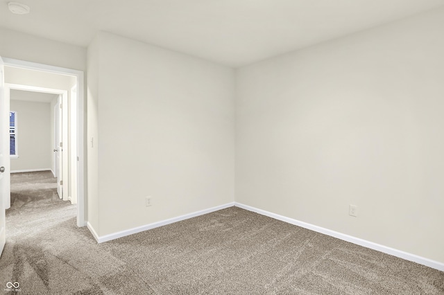 empty room with baseboards and carpet floors