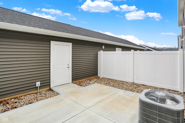 view of patio with central AC and fence