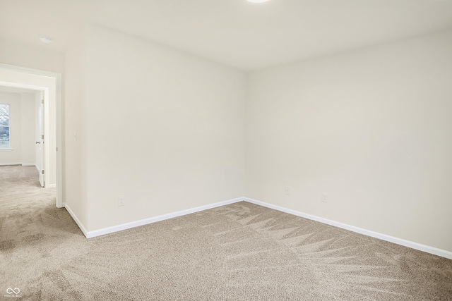 empty room with baseboards and carpet floors