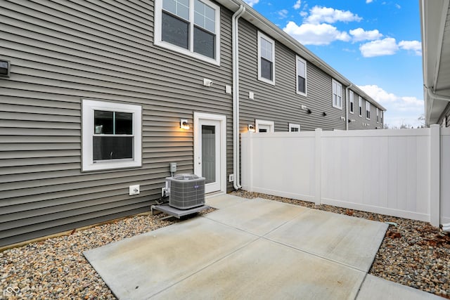 back of house featuring a patio, central AC unit, and fence