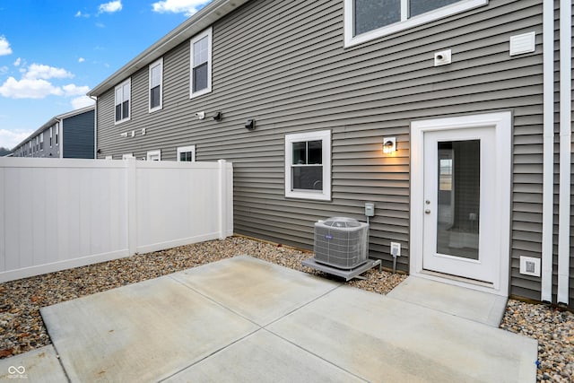 view of patio / terrace with central AC unit and fence