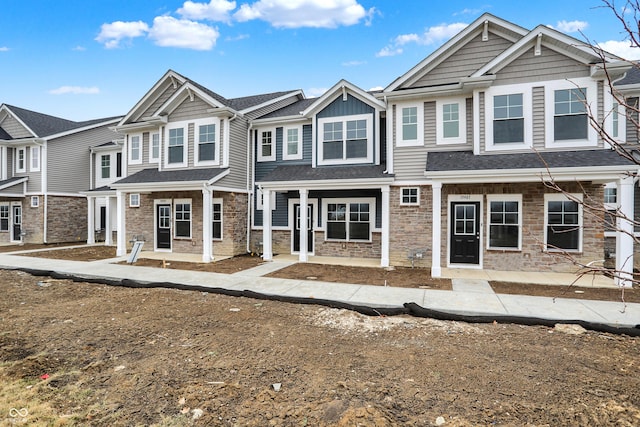 view of front of home featuring stone siding and a residential view