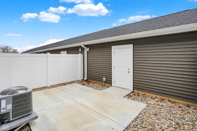 view of patio / terrace with central air condition unit and fence