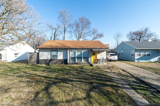 view of front of home with concrete driveway and a front lawn