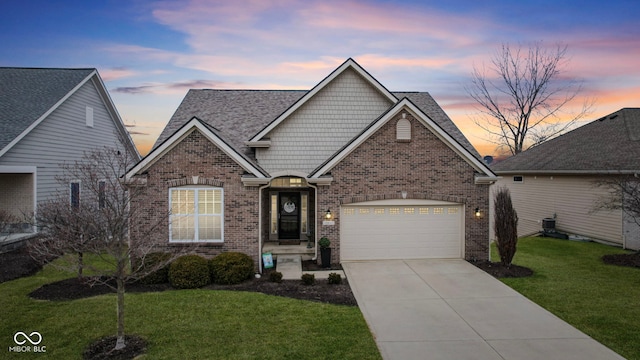 view of front of home featuring brick siding, central air condition unit, concrete driveway, a yard, and an attached garage