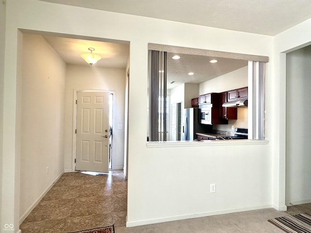 entryway with recessed lighting and baseboards