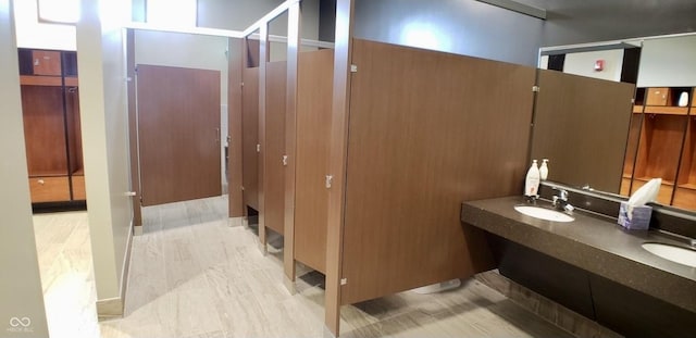 bathroom featuring a sink and double vanity