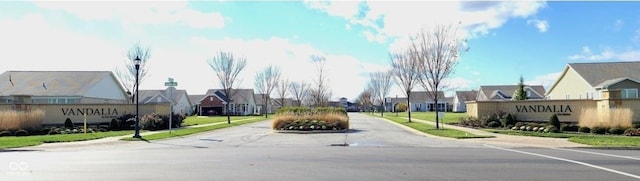 view of road with a residential view, curbs, and sidewalks