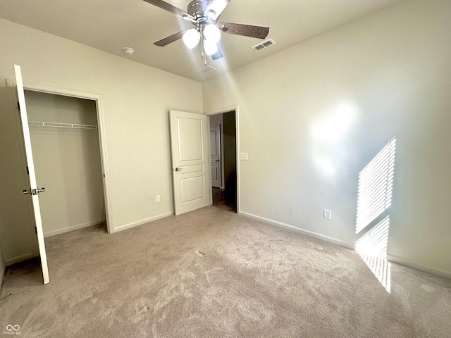 unfurnished bedroom with baseboards, visible vents, carpet floors, and a closet