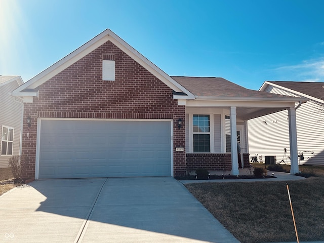 single story home with brick siding, an attached garage, a shingled roof, covered porch, and driveway