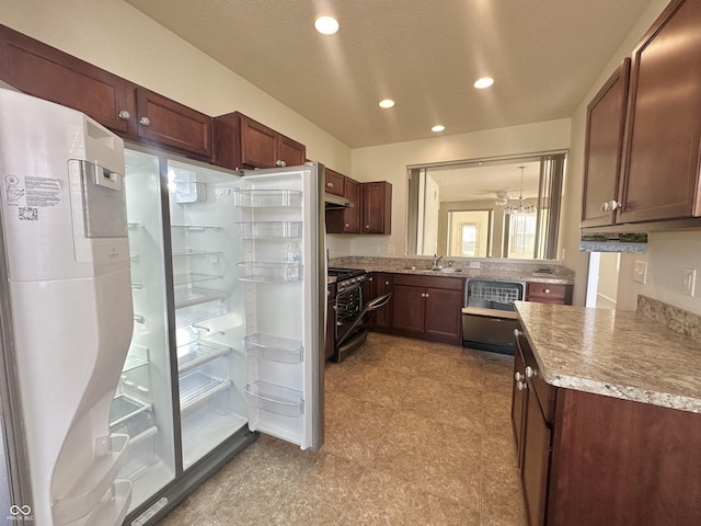 kitchen featuring under cabinet range hood, light countertops, recessed lighting, appliances with stainless steel finishes, and a sink