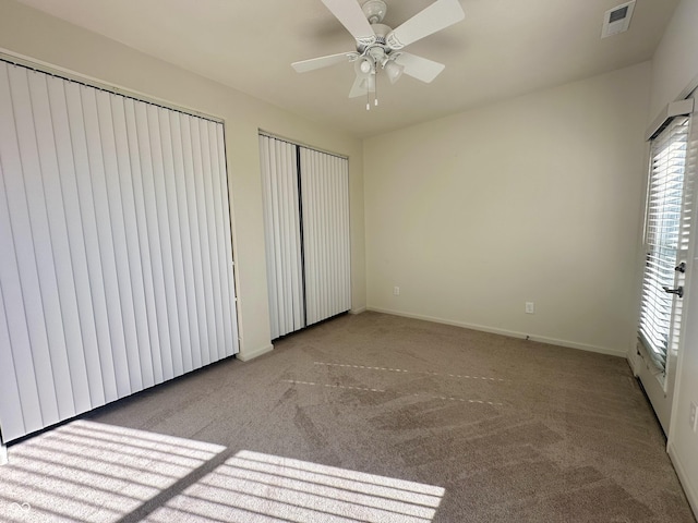 unfurnished bedroom featuring visible vents, carpet flooring, baseboards, and ceiling fan