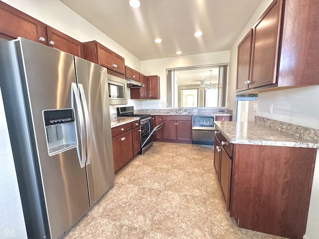 kitchen with a sink, stainless steel appliances, under cabinet range hood, and light countertops