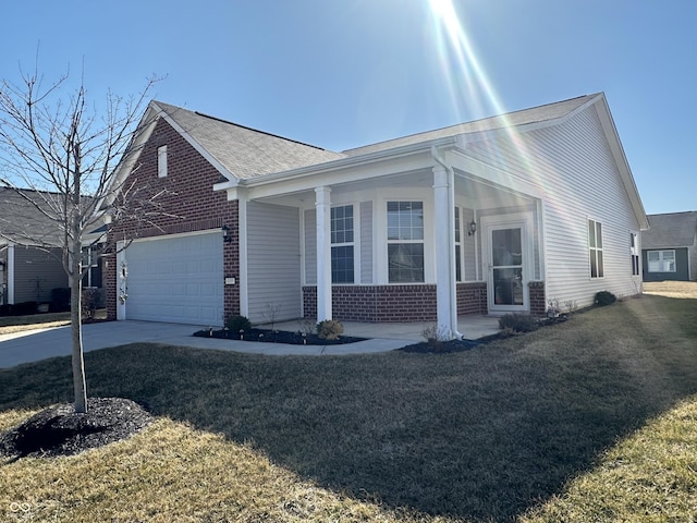 view of front of house featuring a front yard, a porch, concrete driveway, a garage, and brick siding