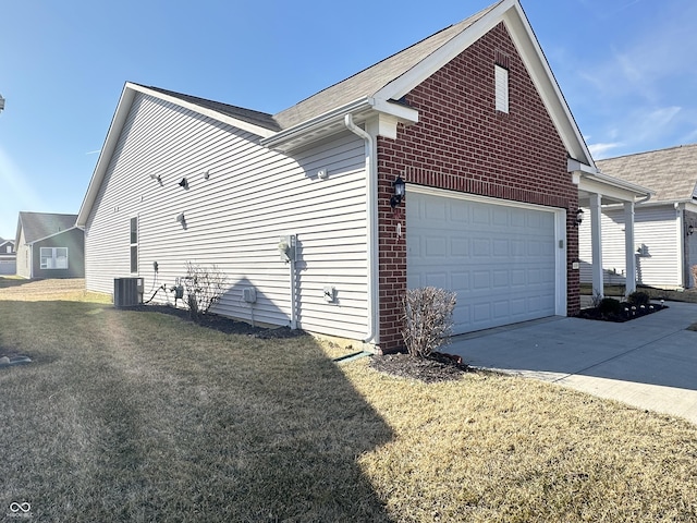 view of side of home with central AC unit, driveway, an attached garage, a lawn, and brick siding