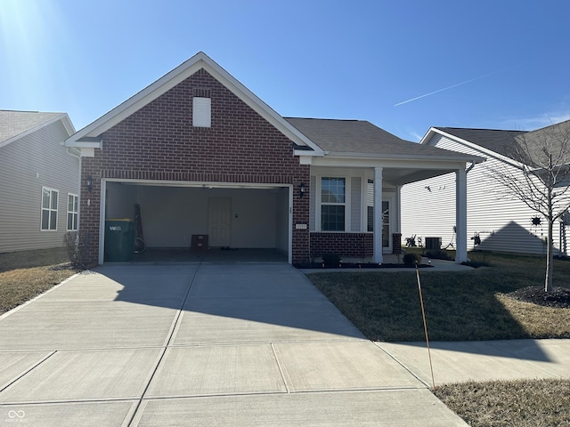 single story home with brick siding, covered porch, an attached garage, and concrete driveway