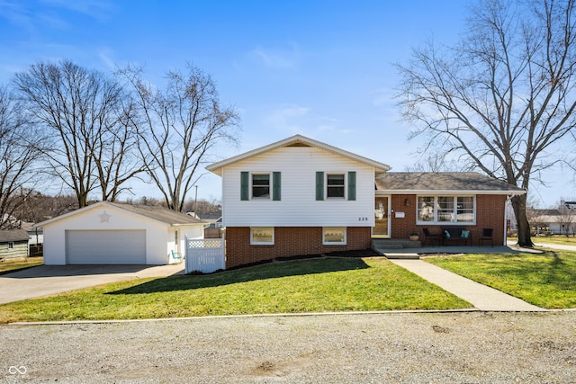 tri-level home with fence, an outdoor structure, a front yard, a garage, and brick siding