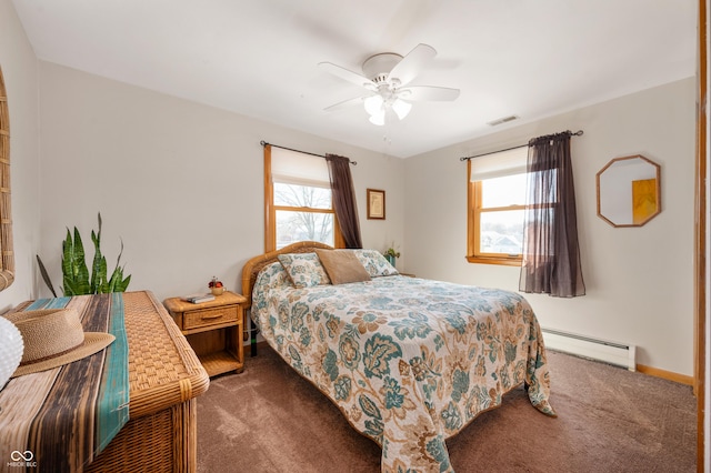 carpeted bedroom featuring a baseboard heating unit, visible vents, and ceiling fan