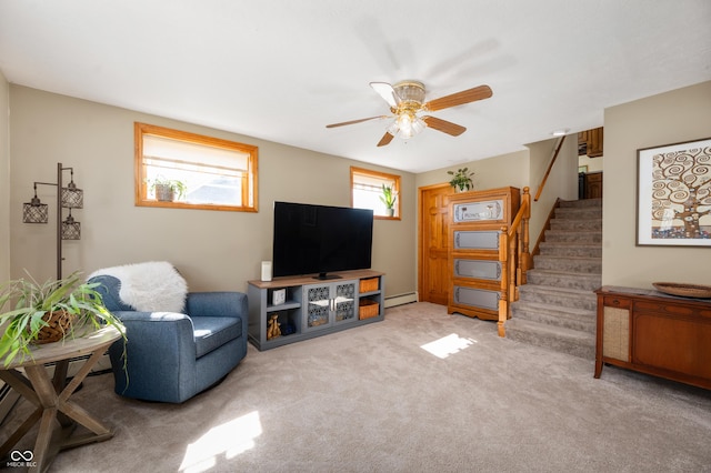 living room featuring stairway, carpet flooring, ceiling fan, and a baseboard radiator