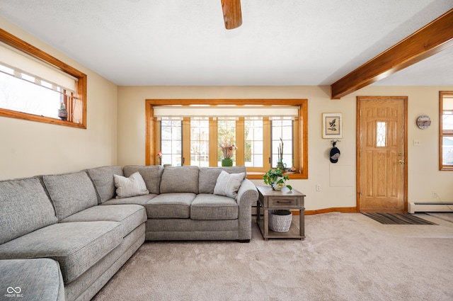 carpeted living room with beam ceiling, a baseboard heating unit, and baseboards