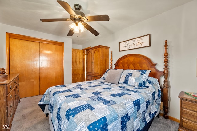 bedroom with baseboards, light colored carpet, a closet, and ceiling fan