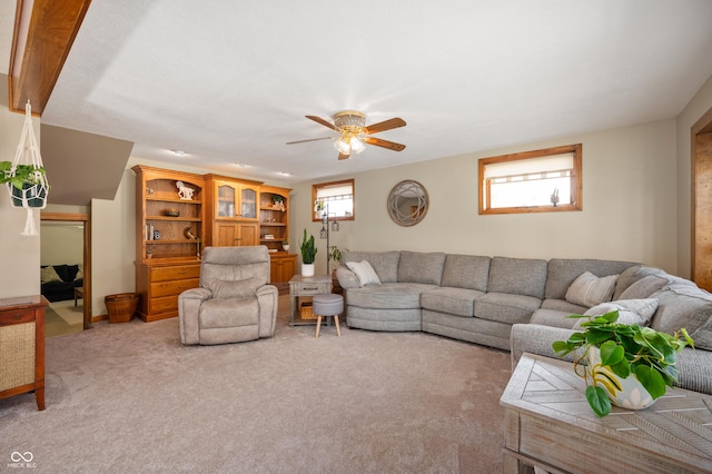 living room featuring a wealth of natural light, light colored carpet, and ceiling fan