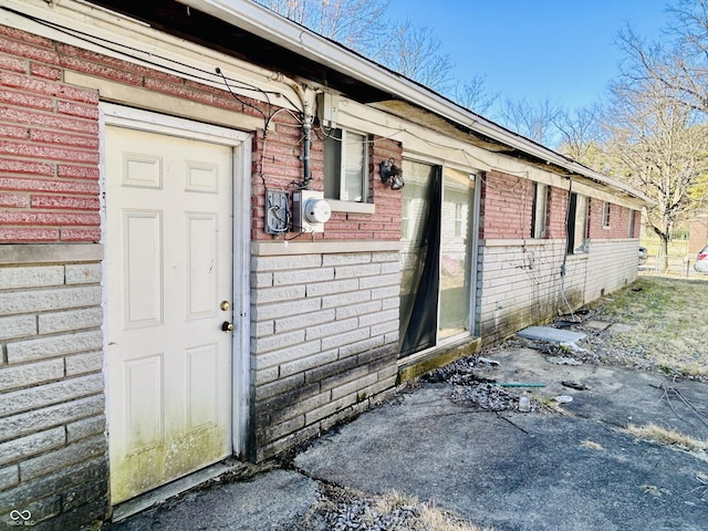 entrance to property with brick siding