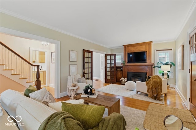 140 E 44th St, Indianapolis, IN 46205 - living area featuring stairway, crown molding, and light wood-style flooring