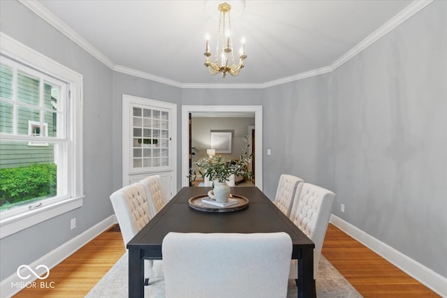 140 E 44th St, Indianapolis, IN 46205 - dining room featuring a wealth of natural light, wood finished floors, crown molding, and a notable chandelier
