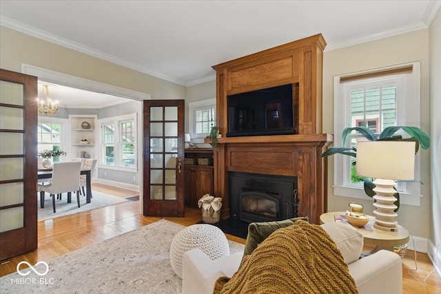 140 E 44th St, Indianapolis, IN 46205 - living room featuring a chandelier, a healthy amount of sunlight, ornamental molding, and baseboards