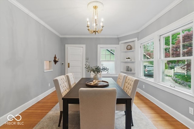 140 E 44th St, Indianapolis, IN 46205 - dining room with wood finished floors, built in features, baseboards, a notable chandelier, and crown molding