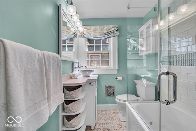 140 E 44th St, Indianapolis, IN 46205 - full bathroom featuring vanity, bath / shower combo with glass door, toilet, visible vents, and baseboards