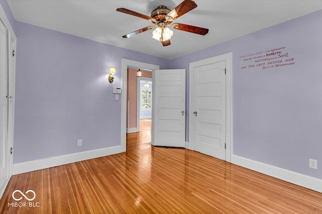 140 E 44th St, Indianapolis, IN 46205 - unfurnished bedroom featuring baseboards, a ceiling fan, light wood-style floors, and a closet