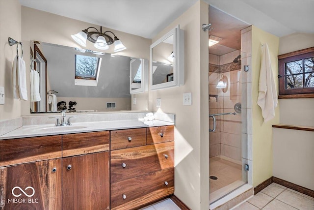 140 E 44th St, Indianapolis, IN 46205 - bathroom with a skylight, tile patterned flooring, a shower stall, vanity, and baseboards