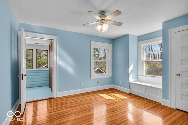 140 E 44th St, Indianapolis, IN 46205 - unfurnished room featuring a ceiling fan, baseboards, wood finished floors, and plenty of natural light