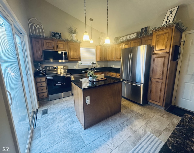 kitchen with dark countertops, visible vents, pendant lighting, appliances with stainless steel finishes, and a sink