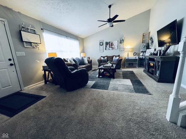 carpeted living room with high vaulted ceiling, a ceiling fan, a textured ceiling, a fireplace, and baseboards