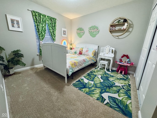 carpeted bedroom featuring baseboards and a textured ceiling