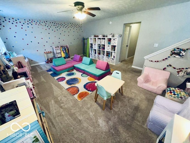 rec room featuring baseboards, carpet, and ceiling fan