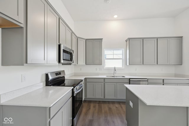 10126 Camp Creek Way, Indianapolis, IN 46229 - kitchen with appliances with stainless steel finishes, gray cabinets, dark wood-style flooring, recessed lighting, and light stone countertops