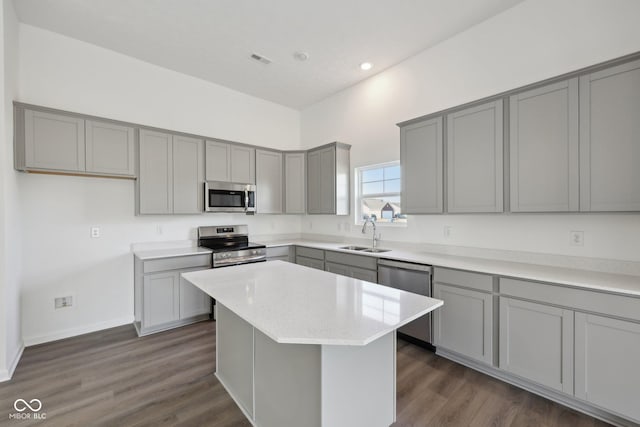 10126 Camp Creek Way, Indianapolis, IN 46229 - kitchen featuring stainless steel appliances, gray cabinets, a center island, dark wood-style floors, and recessed lighting