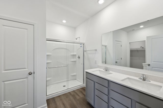 10126 Camp Creek Way, Indianapolis, IN 46229 - bathroom with a shower stall, wood finished floors, double vanity, and recessed lighting