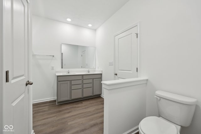 10126 Camp Creek Way, Indianapolis, IN 46229 - bathroom featuring double vanity, wood finished floors, and recessed lighting