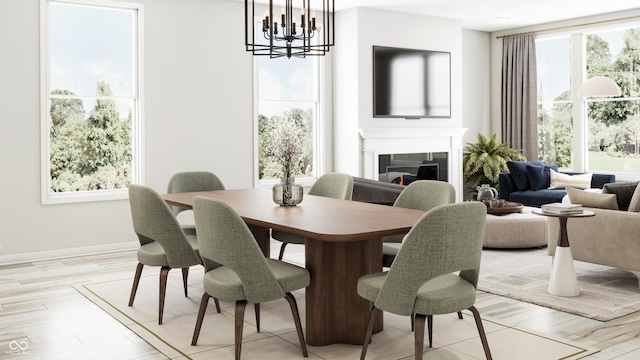 dining space featuring baseboards, light wood-style floors, a warm lit fireplace, and an inviting chandelier