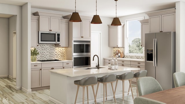 kitchen with light wood-type flooring, a sink, tasteful backsplash, stainless steel appliances, and light countertops