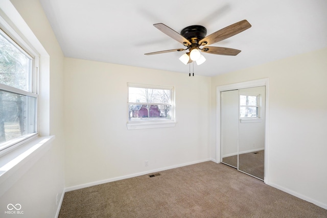 unfurnished bedroom with visible vents, baseboards, carpet, and a closet