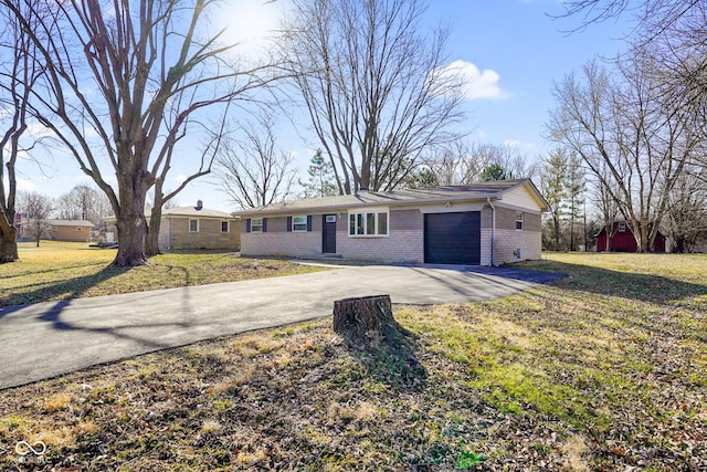 ranch-style home with brick siding, concrete driveway, a garage, and a front yard