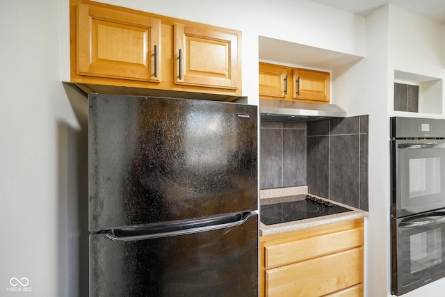 kitchen with black appliances, light brown cabinets, and under cabinet range hood