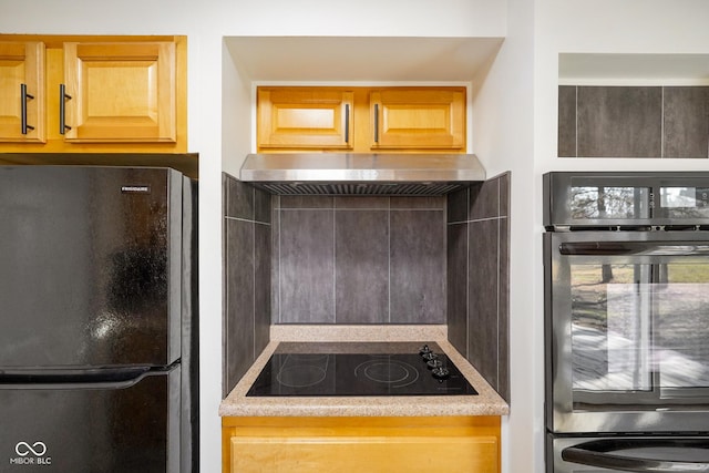 kitchen featuring black appliances and range hood